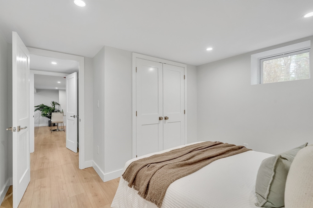 544 Pearl Street Reading, MA 01867 - Photo 17 of 24 a bedroom with a bed and hallway