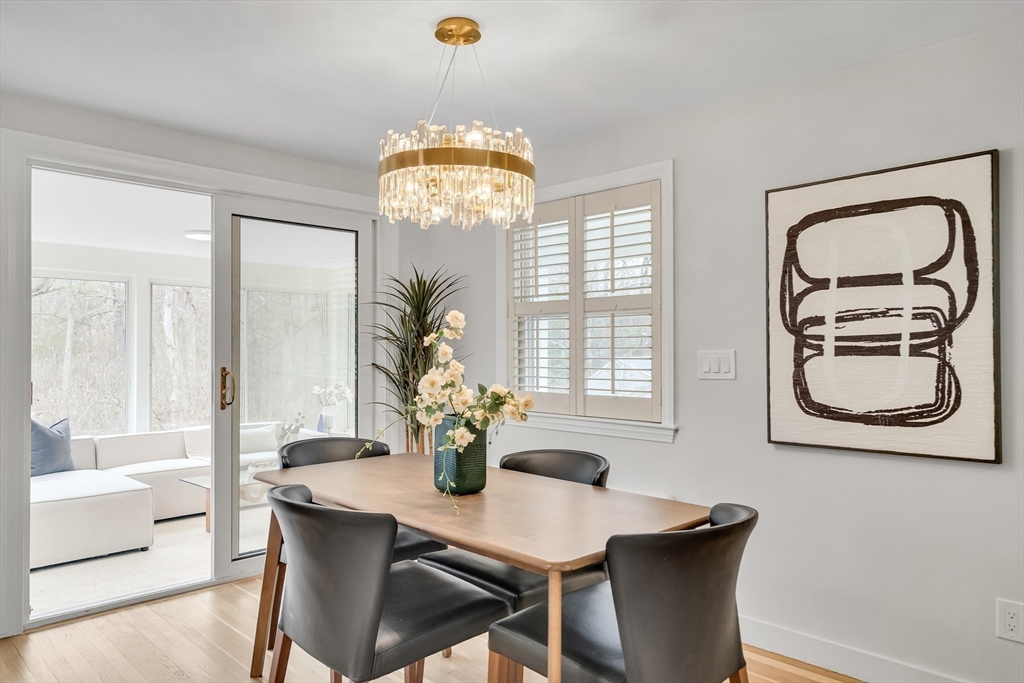 544 Pearl Street Reading, MA 01867 - Photo 8 of 24 a view of a dining room with furniture a chandelier and large windows