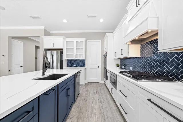 a room with a sink a large mirror and furniture