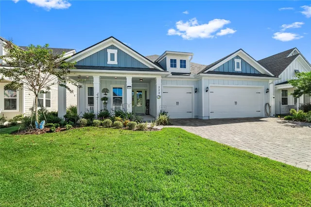 a front view of a house with a yard and porch
