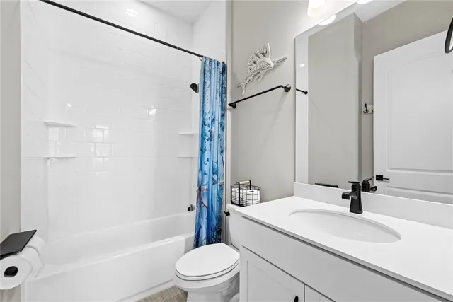 an aerial view of residential houses with outdoor space and seating area