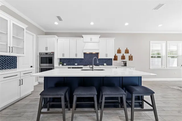 a kitchen with a sink stove and cabinets