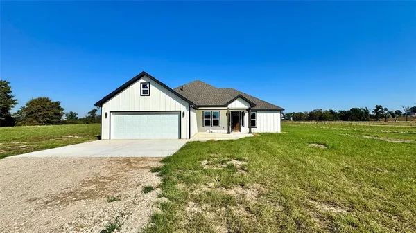a front view of a house with yard