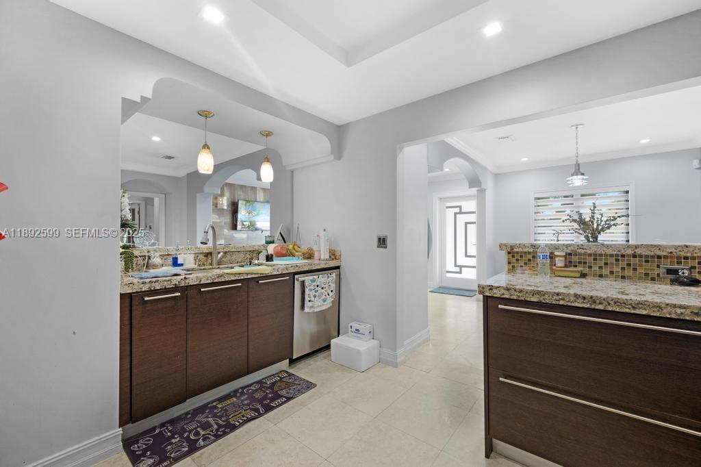 155 West 60th Street Hialeah, FL 33012 - Photo 12 of 29 a kitchen with stainless steel appliances granite countertop a sink and cabinets