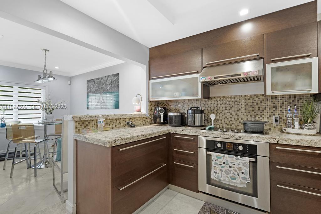 155 West 60th Street Hialeah, FL 33012 - Photo 13 of 29 a kitchen with a stove sink and cabinets