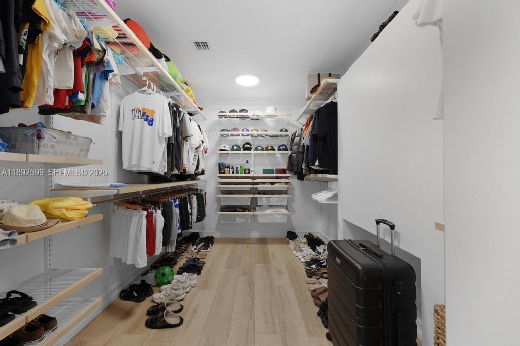 155 West 60th Street Hialeah, FL 33012 - Photo 18 of 29 a view of walk in closet with clothes and shoes