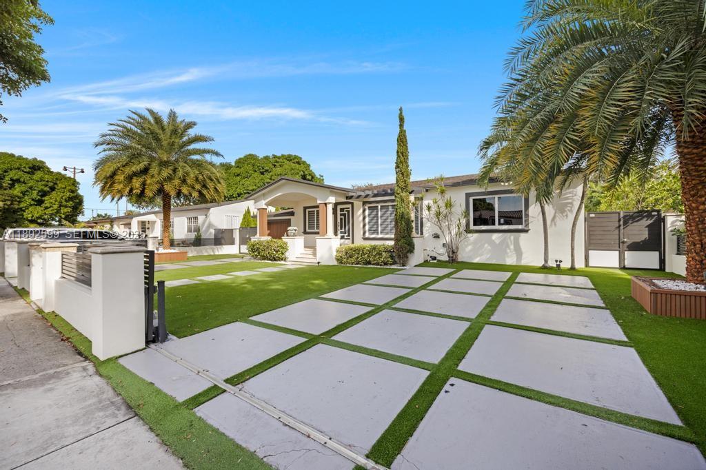 155 West 60th Street Hialeah, FL 33012 - Photo 2 of 29 a front view of a house with a yard and potted plants