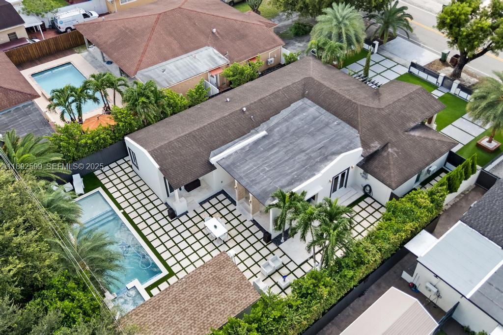 155 West 60th Street Hialeah, FL 33012 - Photo 25 of 29 an aerial view of a house with a yard and plants