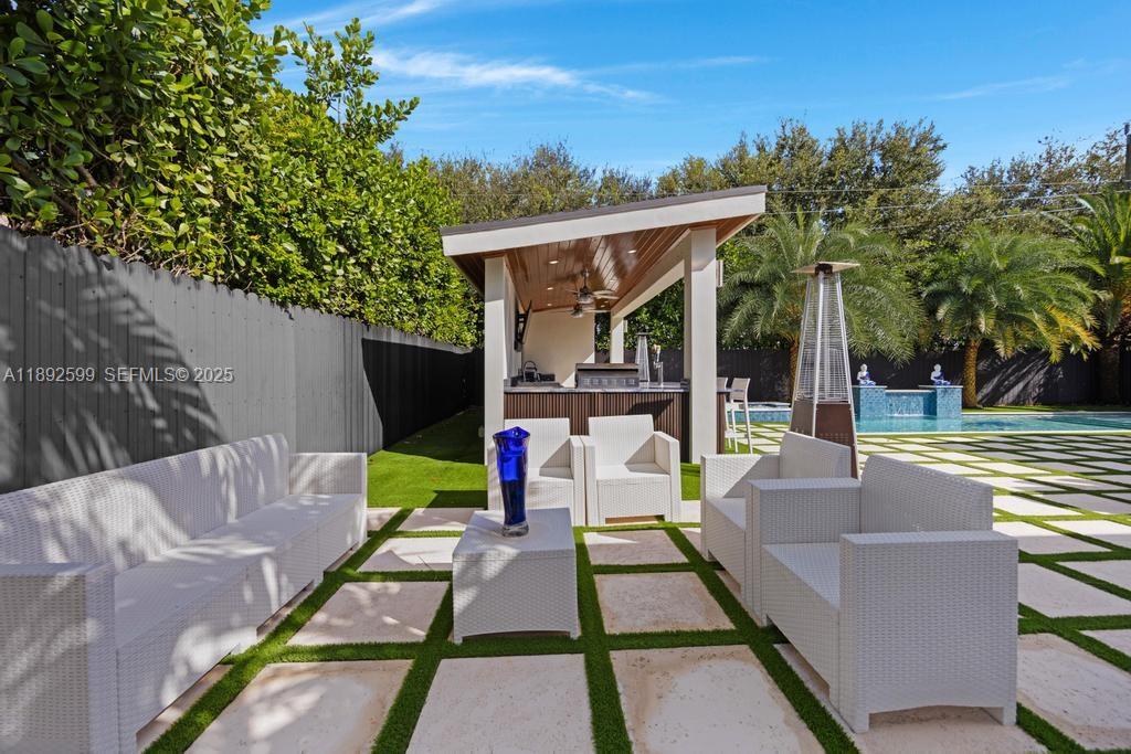 155 West 60th Street Hialeah, FL 33012 - Photo 29 of 29 a view of a patio with couches table and chairs and potted plants