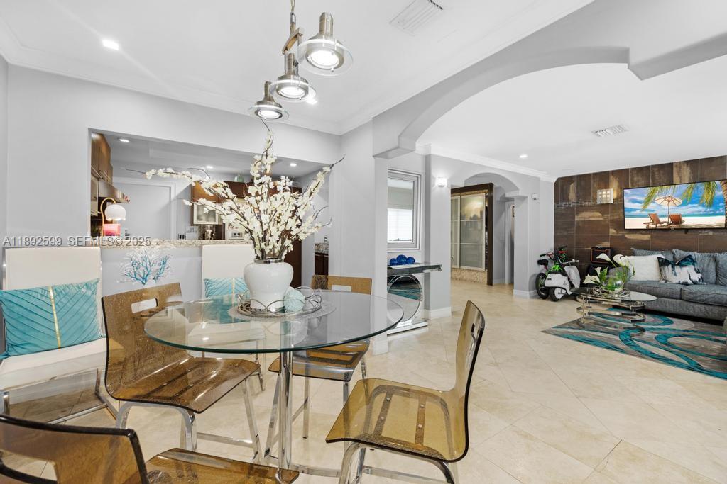 155 West 60th Street Hialeah, FL 33012 - Photo 10 of 29 a dining room with furniture a livingroom and chandelier