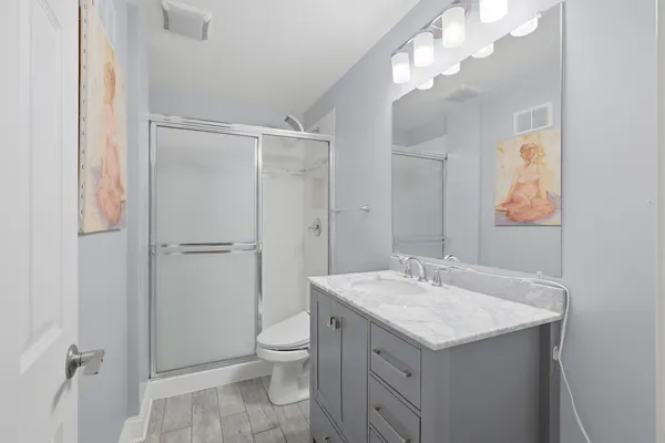 a bathroom with a shower sink and mirror