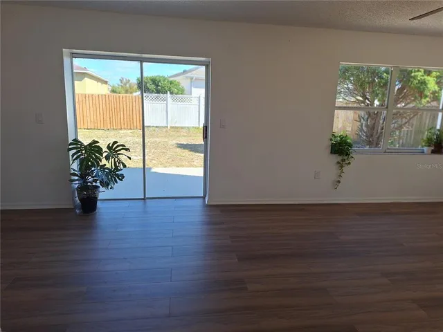 a kitchen with stainless steel appliances a refrigerator sink and wooden floor