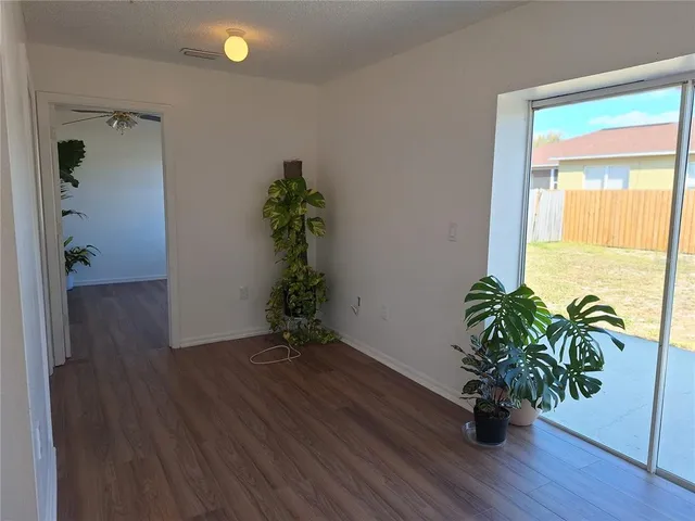 a kitchen with stainless steel appliances granite countertop a stove a refrigerator a sink with wooden cabinets and wooden floor