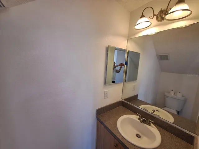 a kitchen with granite countertop a refrigerator sink and cabinets