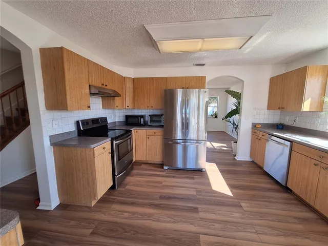 a view of a building with potted plants and a fountain