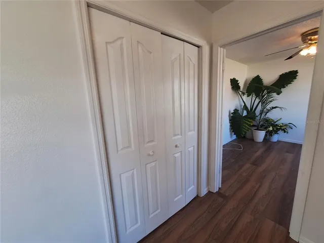 a bathroom with a granite countertop sink a toilet a mirror and shower view