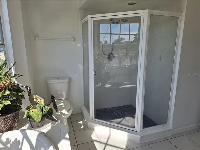 a view of a balcony with chairs and wooden fence