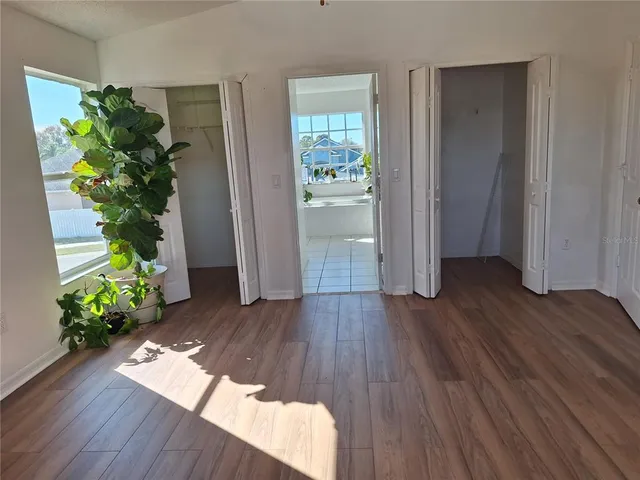 a view of staircase with wooden floor and fan