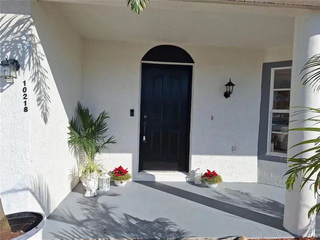 a bathroom with a granite countertop toilet sink and mirror