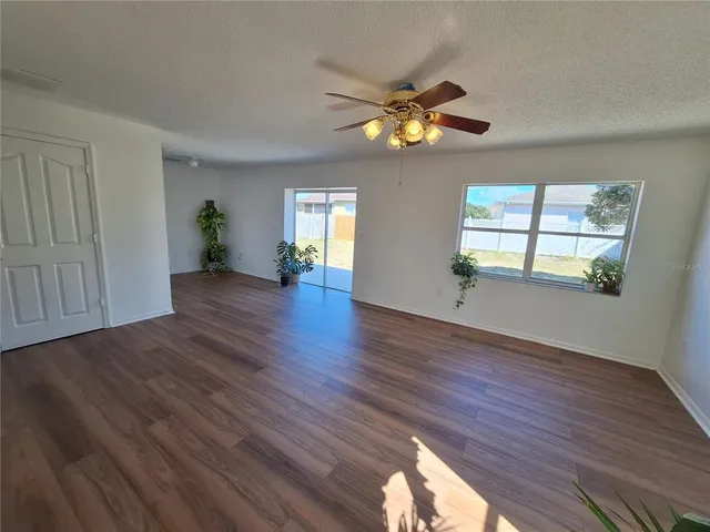 a kitchen with granite countertop wooden floors and stainless steel appliances