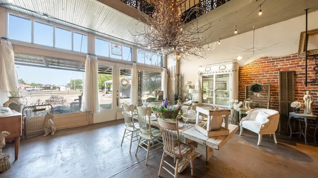 a very nice looking living room with furniture and floor to ceiling windows