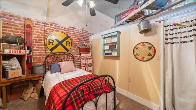 a bedroom with a bed and a wall painting on the wall