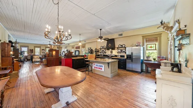 a large kitchen with a table and chairs