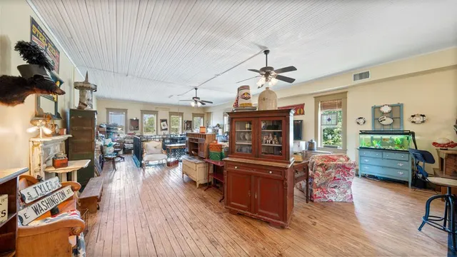 a view of a livingroom with furniture and a window