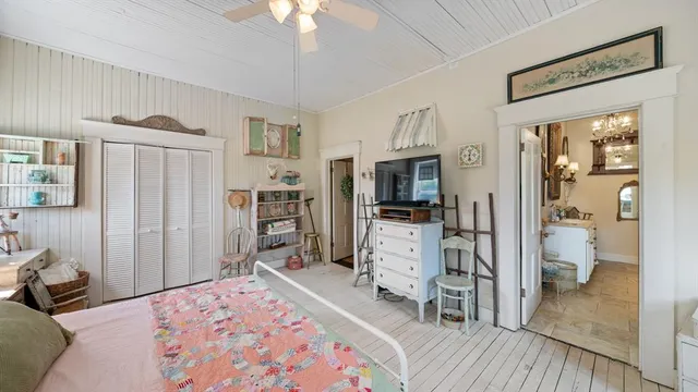 a bedroom with furniture and a flat screen tv