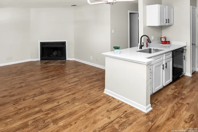 a kitchen with a sink and a stove top oven