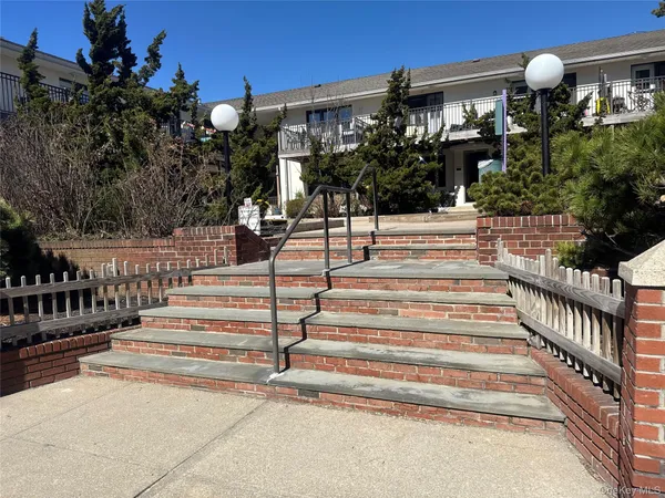a view of building with yard and staircase