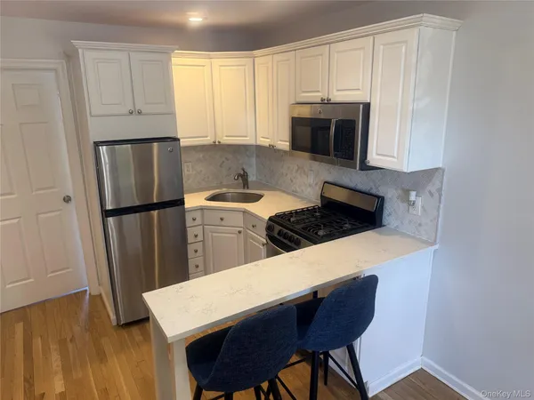a kitchen with a table chairs stove and cabinets