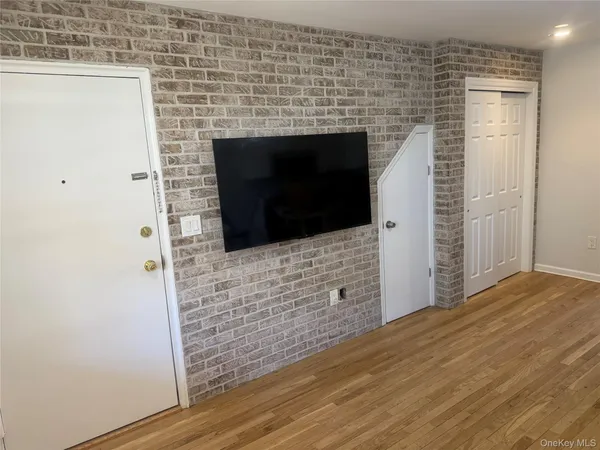 a view of an empty room and wooden floor