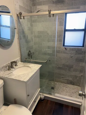 a bathroom with a sink toilet and shower