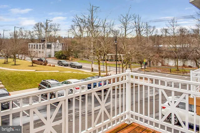 a view of a swimming pool with a yard and lake view