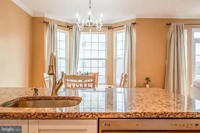 a bathroom with a granite countertop sink and a large mirror