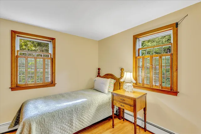 a kitchen with granite countertop wooden cabinets stainless steel appliances a sink and a large window