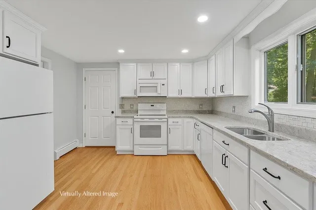 a view of an empty room with window and stairs