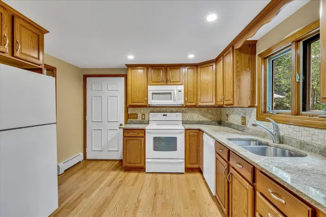 a view of an entryway with wooden floor