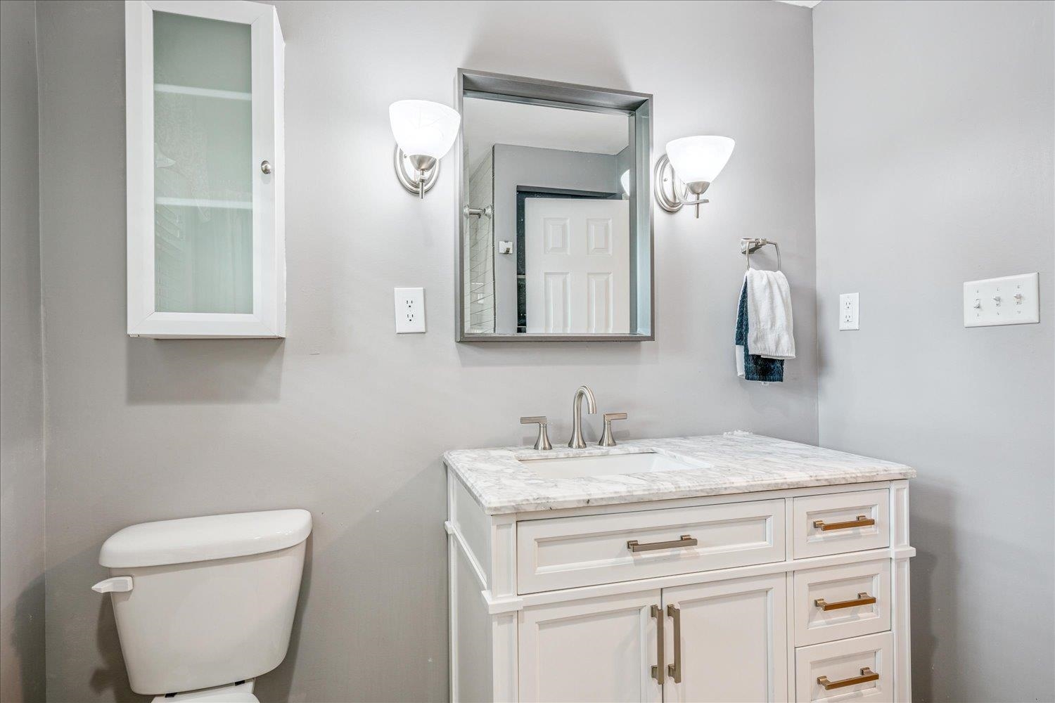 1588 Colonial Road Memphis, TN 38117 - Photo 26 of 35 a bathroom with a toilet sink and mirror