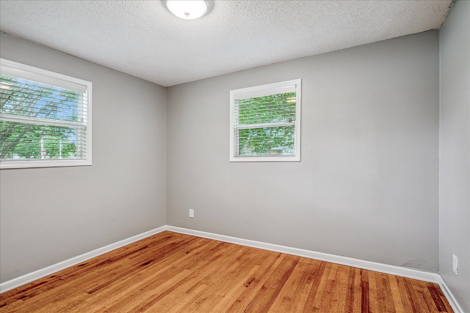 1588 Colonial Road Memphis, TN 38117 - Photo 29 of 35 wooden floor in an empty room with a window