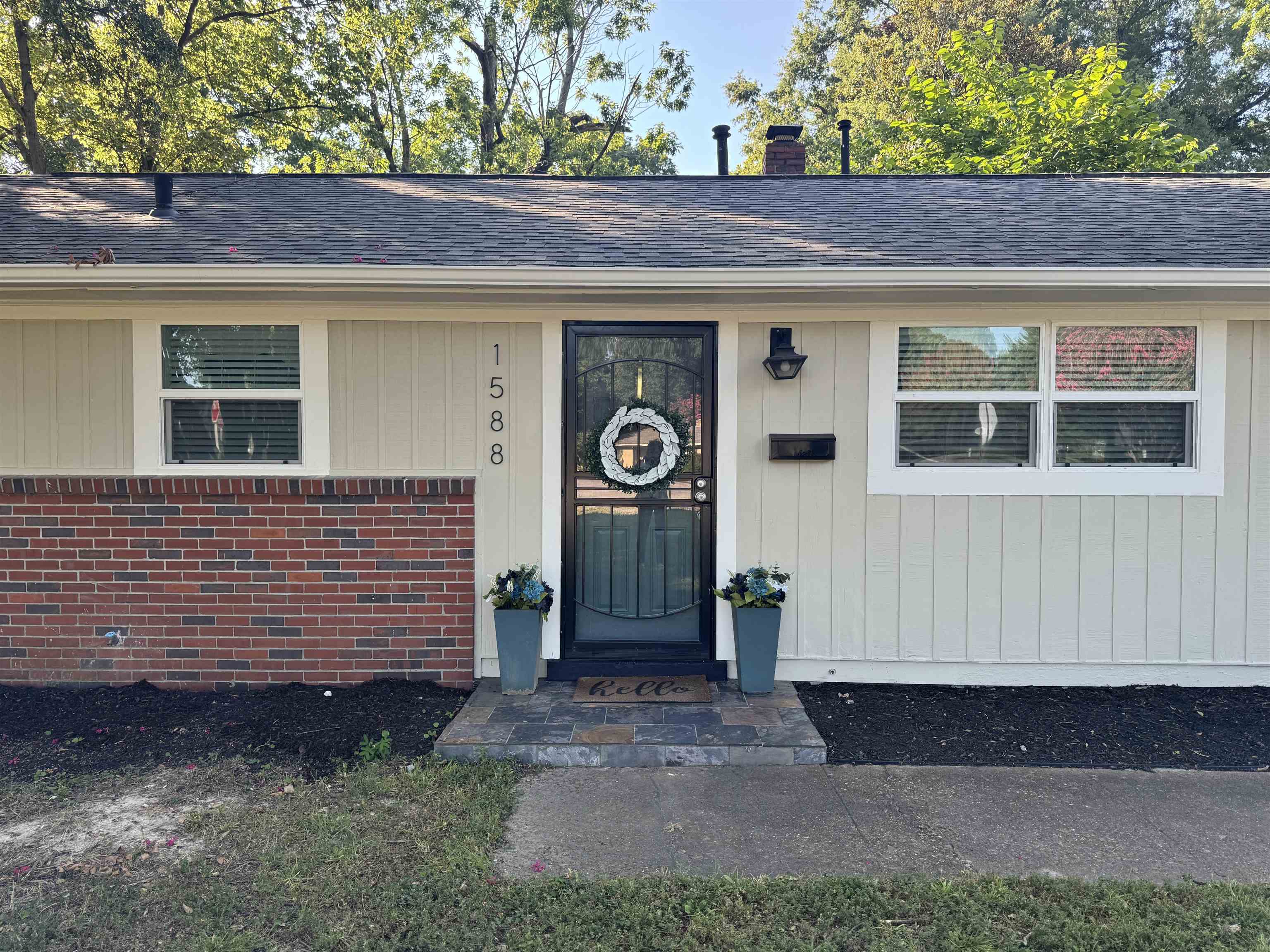 1588 Colonial Road Memphis, TN 38117 - Photo 6 of 35 a front view of a house with a garden