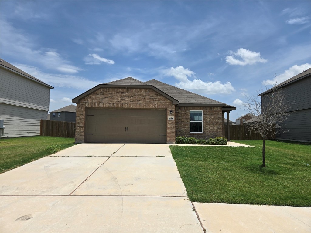 Ranch-style home with brick siding, an attached garage, driveway, and a shingled roof