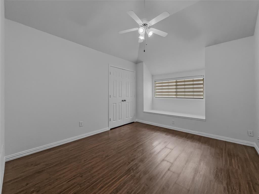 2317 Wellesly Road Rowlett, TX 75089 - Photo 26 of 39 a view of an empty room with wooden floor and a window