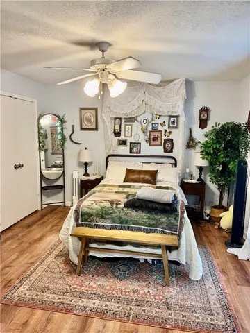 a bedroom with a bed a dresser and chair