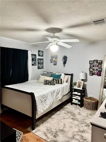 a bedroom with bed and a chandelier