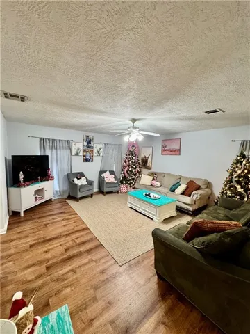 a bedroom with furniture and a flat screen tv