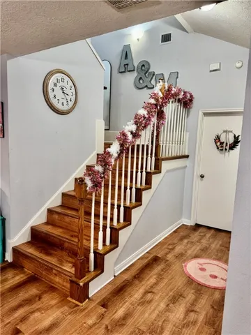 a view of entryway with stairs and wooden floor