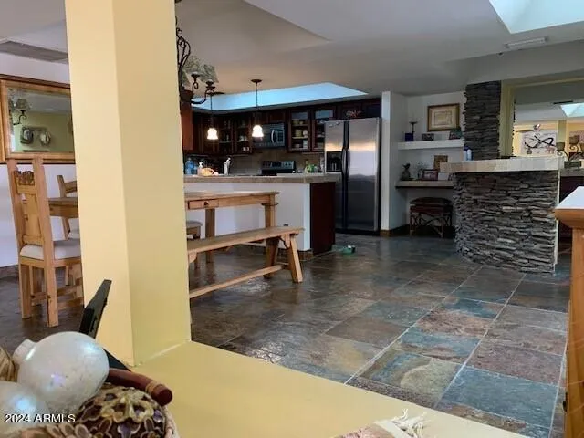 a kitchen with stainless steel appliances kitchen island granite countertop a refrigerator and a stove