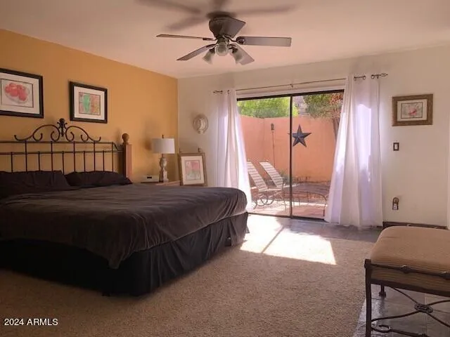a spacious bedroom with a bed and a chandelier